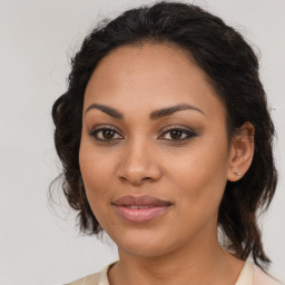 Joyful latino young-adult female with medium  brown hair and brown eyes