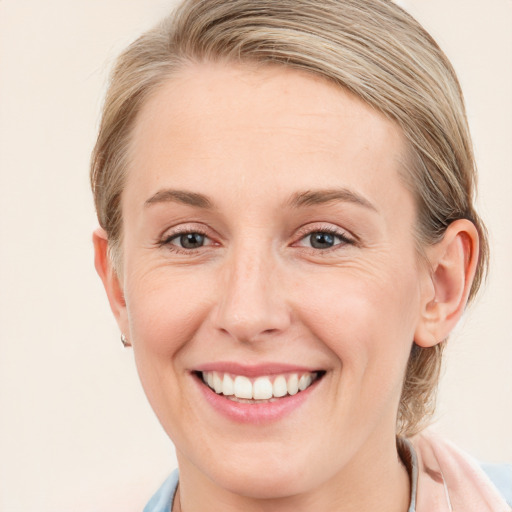 Joyful white young-adult female with medium  brown hair and blue eyes