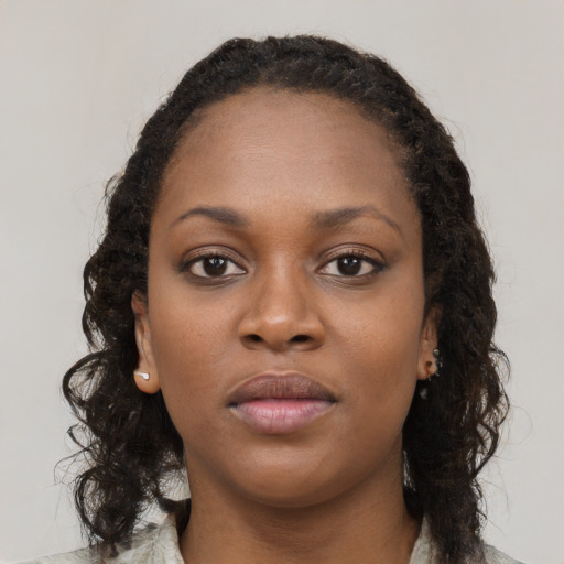 Neutral black young-adult female with long  brown hair and brown eyes