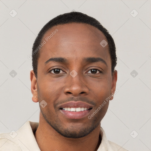 Joyful black young-adult male with short  brown hair and brown eyes