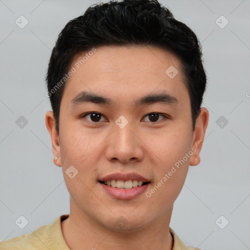 Joyful asian young-adult male with short  black hair and brown eyes