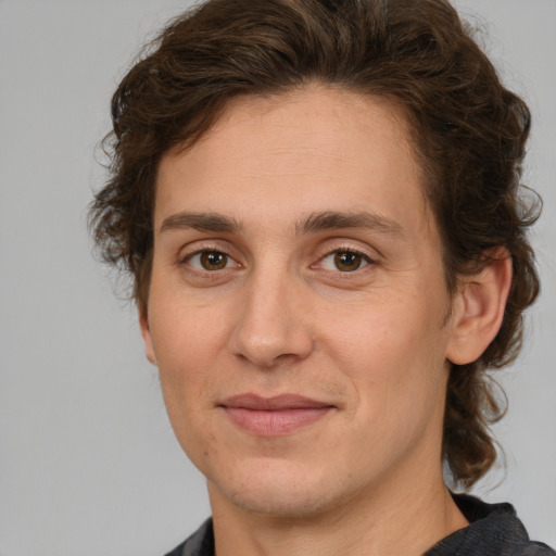 Joyful white adult male with medium  brown hair and brown eyes