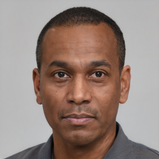 Neutral black adult male with short  black hair and brown eyes