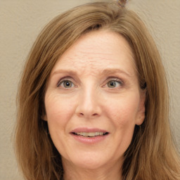 Joyful white adult female with long  brown hair and brown eyes