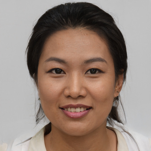 Joyful asian young-adult female with medium  brown hair and brown eyes