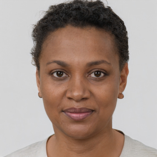 Joyful black adult female with short  brown hair and brown eyes