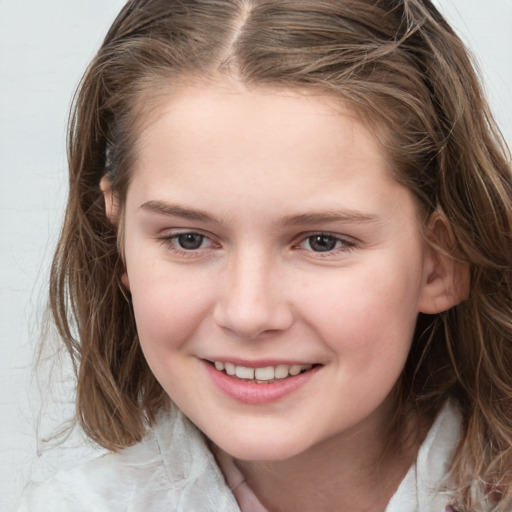 Joyful white child female with medium  brown hair and grey eyes