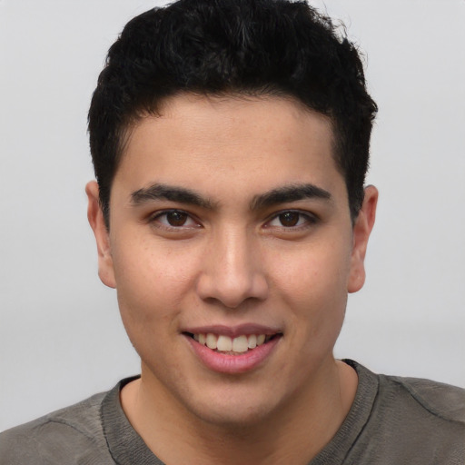 Joyful latino young-adult male with short  brown hair and brown eyes