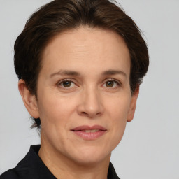 Joyful white adult female with short  brown hair and brown eyes