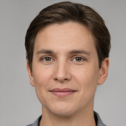 Joyful white adult male with short  brown hair and grey eyes