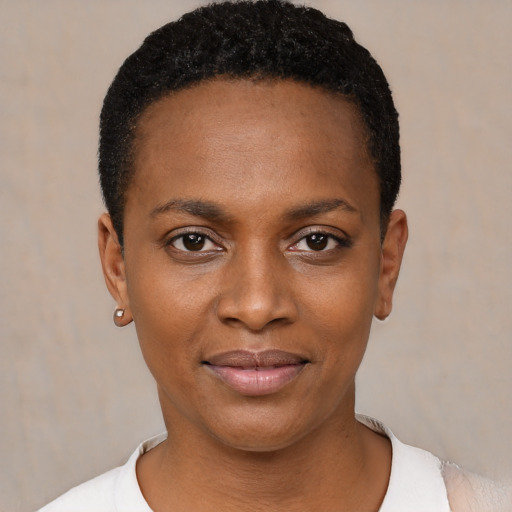 Joyful black young-adult female with short  black hair and brown eyes