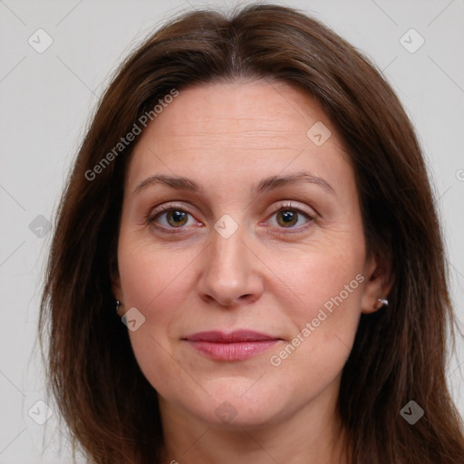 Joyful white adult female with long  brown hair and brown eyes