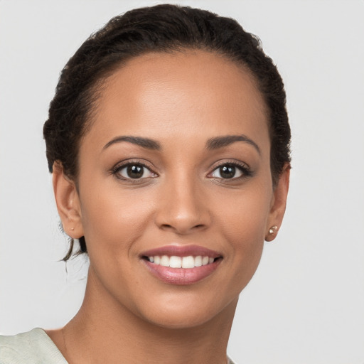 Joyful latino young-adult female with short  brown hair and brown eyes