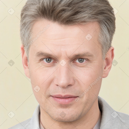 Joyful white adult male with short  brown hair and grey eyes