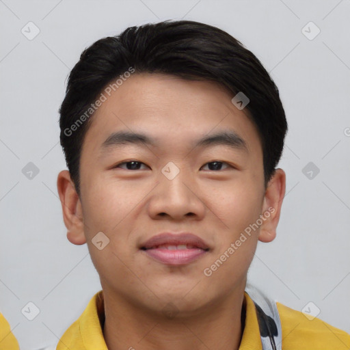Joyful asian young-adult male with short  black hair and brown eyes