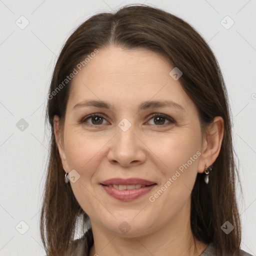 Joyful white adult female with long  brown hair and brown eyes