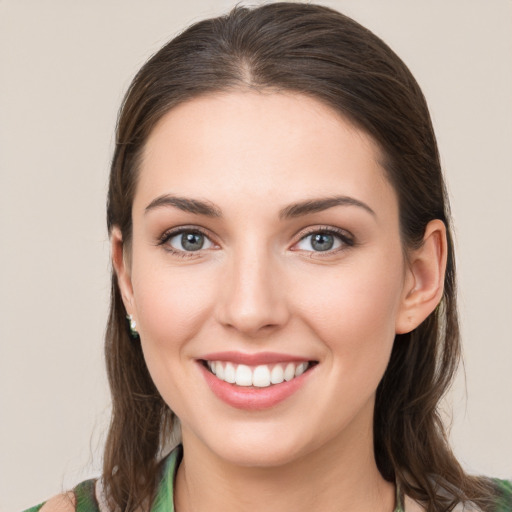 Joyful white young-adult female with medium  brown hair and green eyes