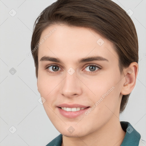 Joyful white young-adult female with medium  brown hair and grey eyes