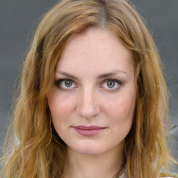 Joyful white young-adult female with long  brown hair and blue eyes