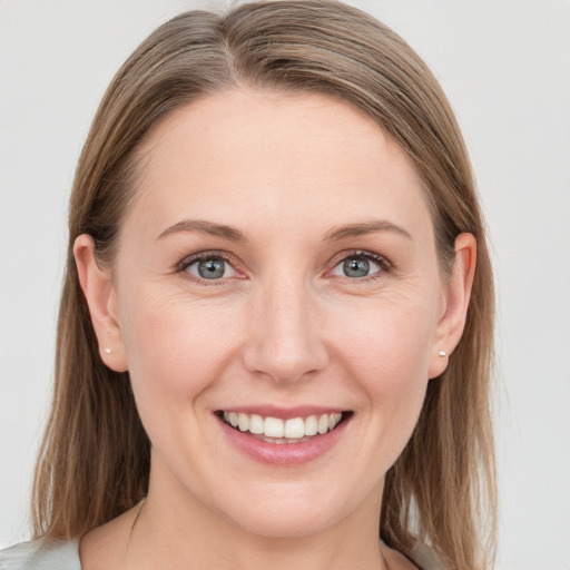 Joyful white young-adult female with medium  brown hair and blue eyes