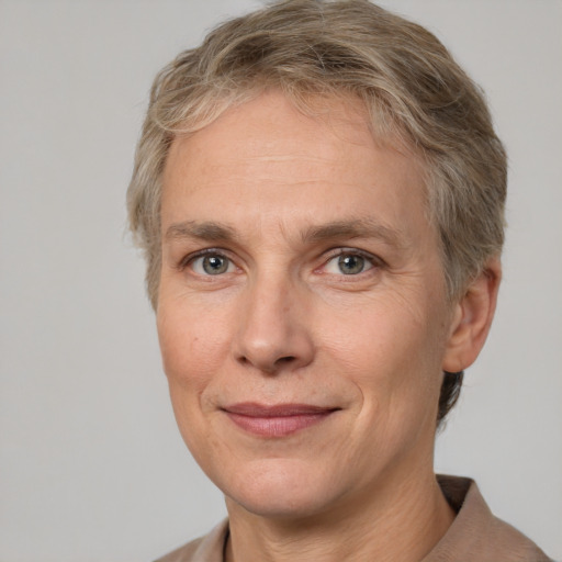 Joyful white adult female with short  brown hair and grey eyes