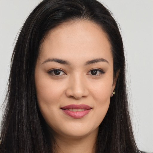 Joyful asian young-adult female with long  brown hair and brown eyes