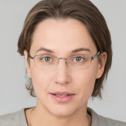 Joyful white adult female with medium  brown hair and grey eyes