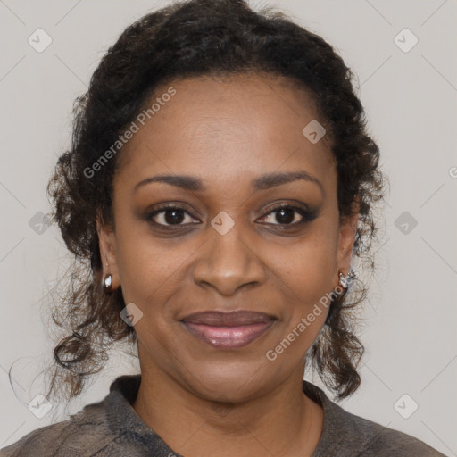 Joyful black adult female with medium  brown hair and brown eyes