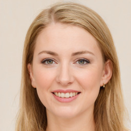 Joyful white young-adult female with long  brown hair and green eyes