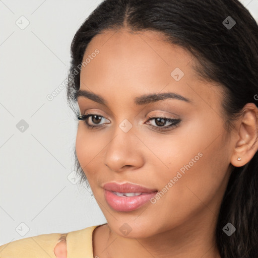 Joyful latino young-adult female with long  brown hair and brown eyes