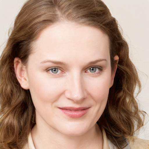 Joyful white young-adult female with medium  brown hair and blue eyes