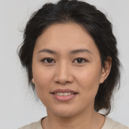 Joyful asian young-adult female with medium  brown hair and brown eyes