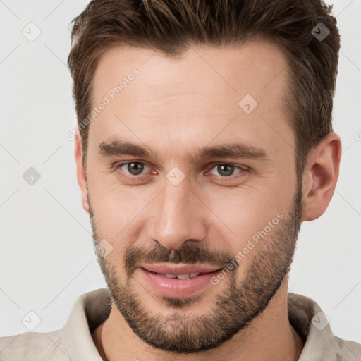 Joyful white young-adult male with short  brown hair and brown eyes