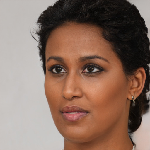 Neutral black young-adult female with long  brown hair and brown eyes