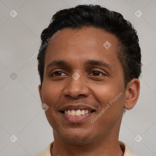 Joyful black young-adult male with short  black hair and brown eyes