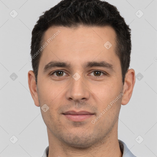 Joyful white young-adult male with short  black hair and brown eyes