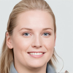 Joyful white young-adult female with long  brown hair and blue eyes