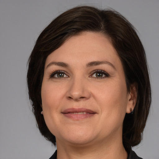 Joyful white adult female with medium  brown hair and brown eyes