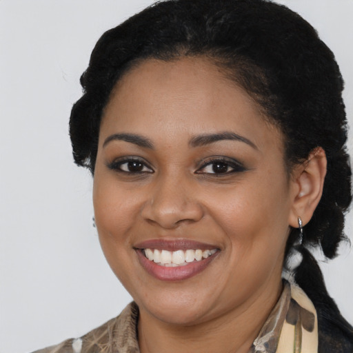 Joyful black young-adult female with medium  brown hair and brown eyes