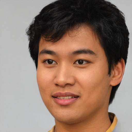 Joyful asian young-adult male with short  black hair and brown eyes