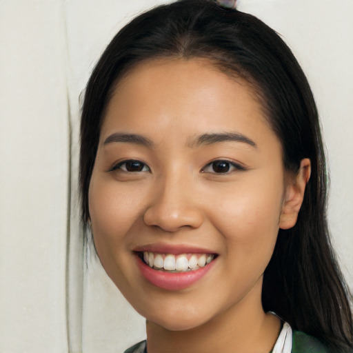 Joyful latino young-adult female with long  black hair and brown eyes