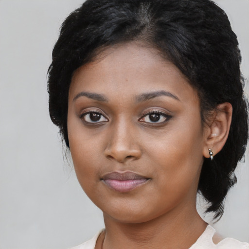 Joyful latino young-adult female with medium  black hair and brown eyes
