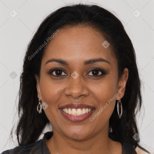 Joyful black young-adult female with long  brown hair and brown eyes