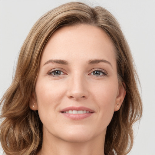 Joyful white young-adult female with long  brown hair and green eyes