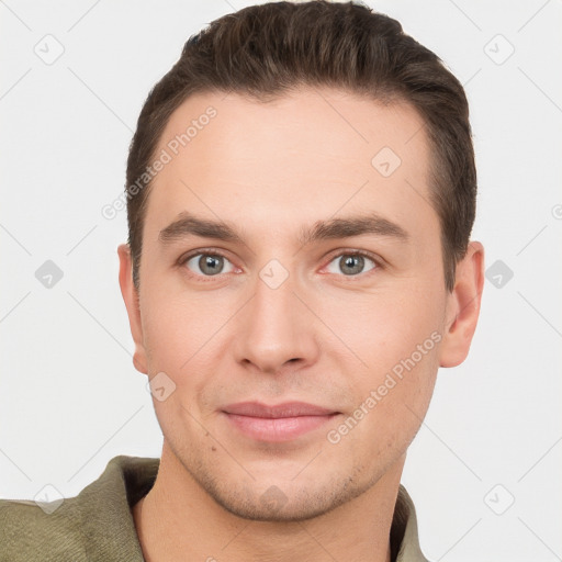 Joyful white young-adult male with short  brown hair and grey eyes