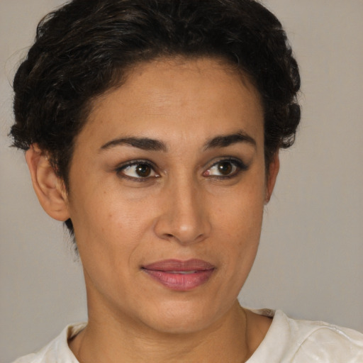 Joyful latino young-adult female with short  brown hair and brown eyes