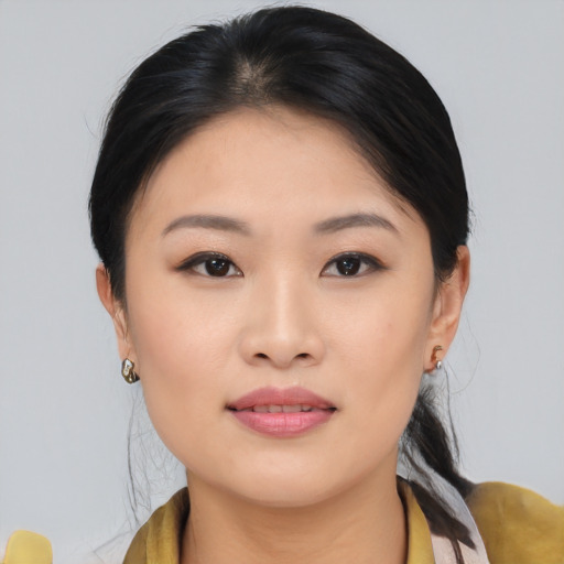 Joyful asian young-adult female with medium  brown hair and brown eyes
