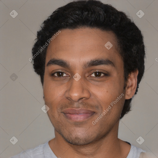 Joyful black young-adult male with short  black hair and brown eyes