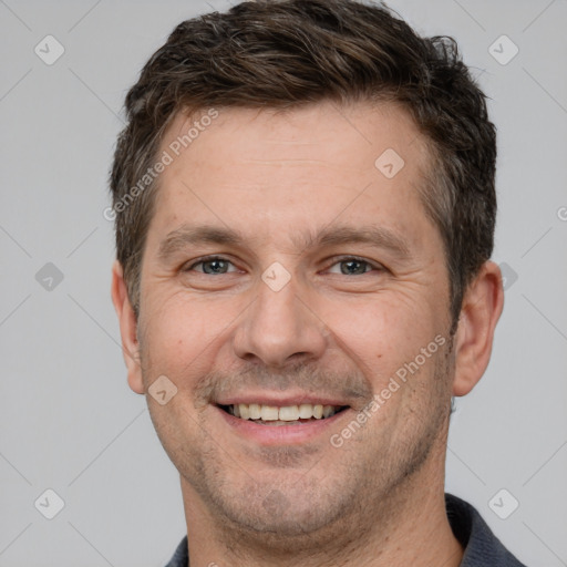 Joyful white adult male with short  brown hair and brown eyes