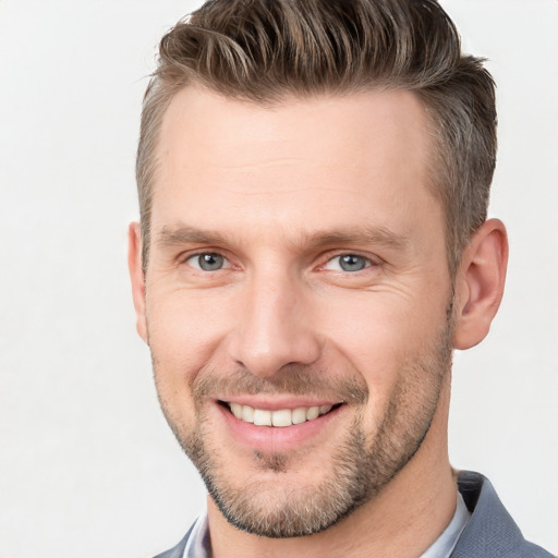 Joyful white adult male with short  brown hair and grey eyes